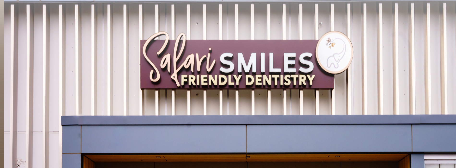 Dental practice sign with the text SALIS and Smiles in a stylized font, indicating a dental clinic named Salis Smiles.